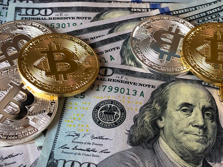 About A close-up photo depicting Bitcoin coins on top of US dollar bills, symbolizing finance and cryptocurrency.
